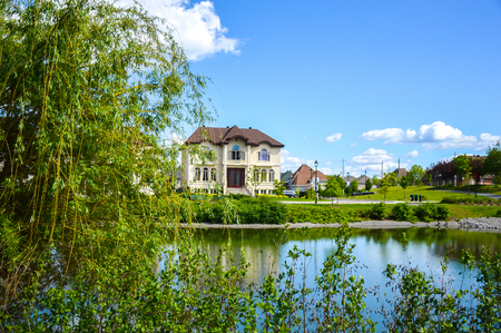 Small pond in the neighborhood with the expensive buildingsの写真素材