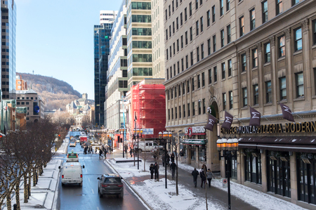 People walking in Montreal downtown in Montreal near Mcgill University among skyscrapersのeditorial素材