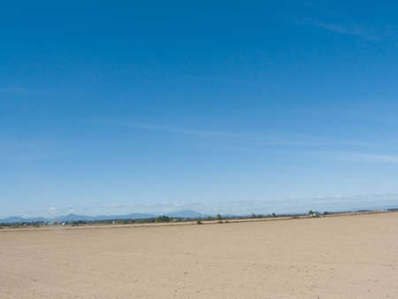 Field ready to be planted with a dark blue skyの写真素材