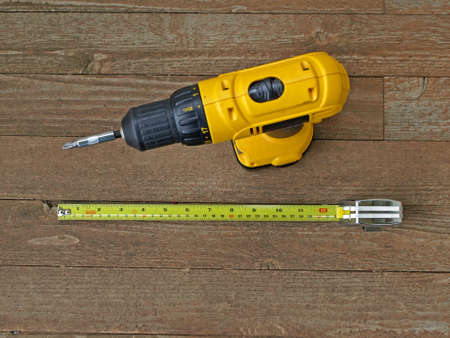Two construction tools sitting on a wooden floorの写真素材
