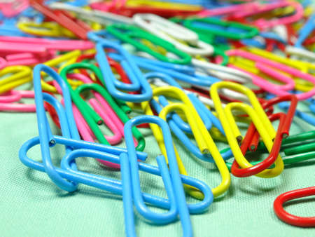 colourfull paper clips on light green backgroundの写真素材