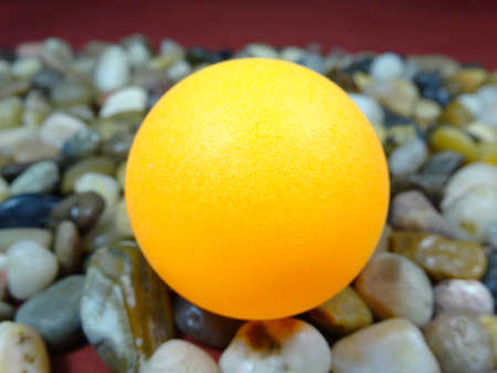 A  table tennis ball in river rock backgroundの写真素材