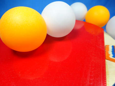 red table tennis bat and ping pong ball in blue backgroundの写真素材
