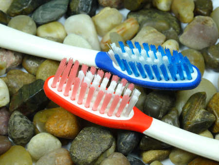 colourful toothbrush on river stone backgroundの写真素材