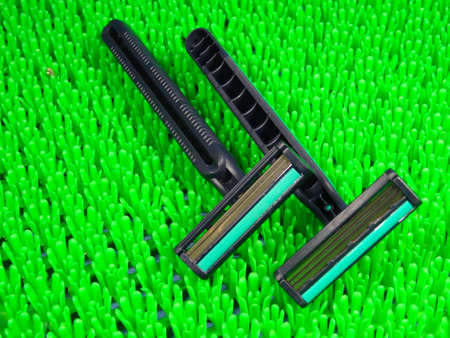 Razor in artificial green grass background. photo taken in Malaysia