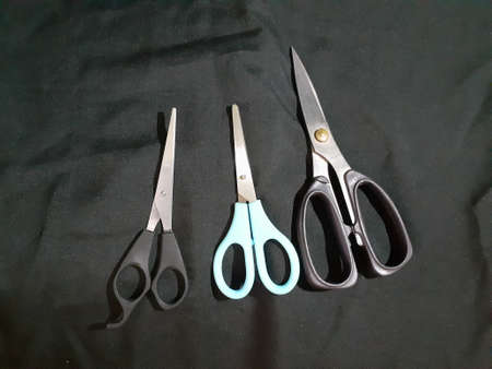 A blue scissor on black background. photo taken in Malaysia