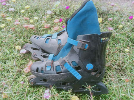 a pair of blue coloured  old adult roller blade . photo taken in malaysia