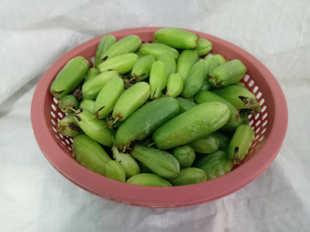 many bilimbi fruits in a basket close up on white background. photo taken in malaysiaの写真素材
