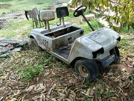 Old rusty car on the ground in the garden, malaysiaの写真素材