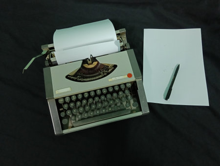Old vintage typewriter, paper and a pen   on a black background, closeup of photo taken in malaysia