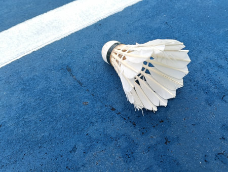 shuttlecock on a blue  badminton court outside the line on blue background close up. Photo taken in Malaysiaの写真素材
