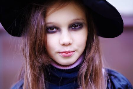 Portrait of a teenage girl in a witch costume