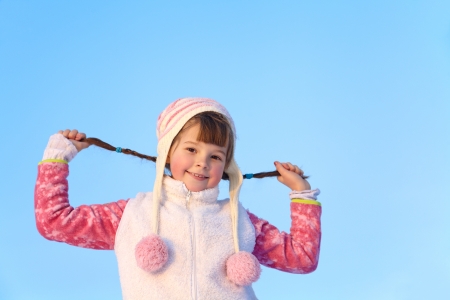 portrait of a girl walking around outdoors in the winter, keeps herself pigtailsの写真素材