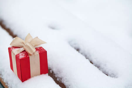 winter Christmas gift box in the snow outdoors.の写真素材