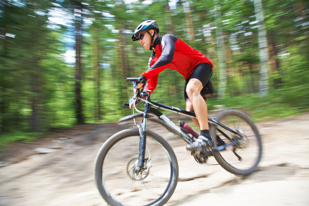 young male riding a mountain bike outdoorの写真素材