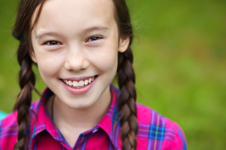 Beautiful smiling teenage girl in a summer park. youth lifestyleの写真素材