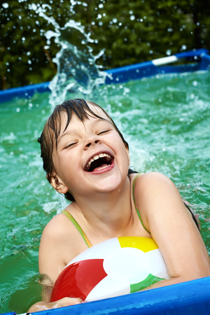 funny little girl in swimming pool. children outdoorsの写真素材