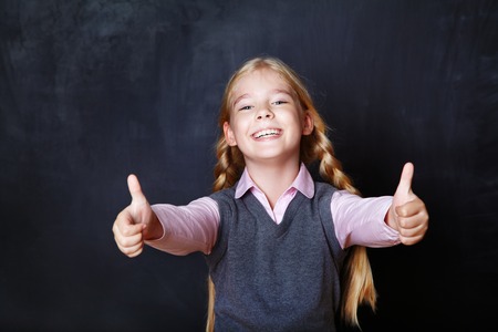 Portrait of a schoolchild on a background of the board. School and educationの写真素材