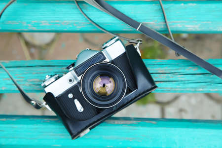 Old retro camera on vintage wooden boards. abstract background