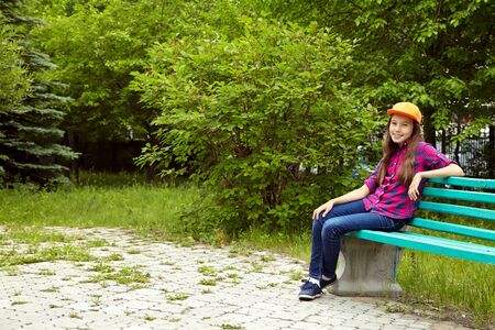 Beautiful smiling teenage girl in a summer park. youth lifestyleの写真素材