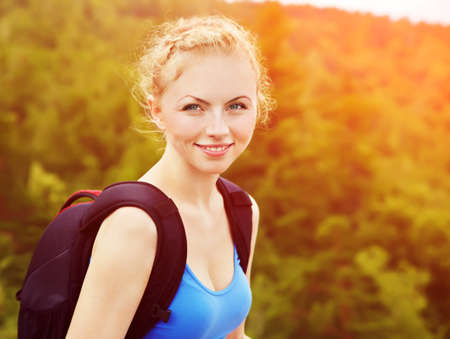 young woman with backpack hiking in the mountains. people outdoorsの写真素材
