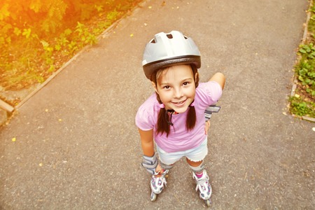 Little girl in roller skates at a parkの写真素材