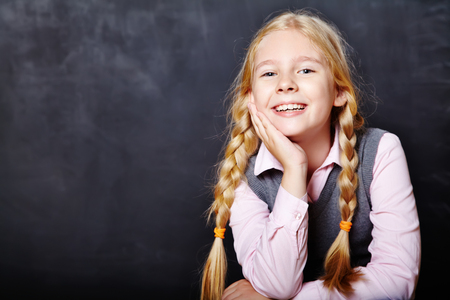 schoolchild on blackboard backgroundの写真素材