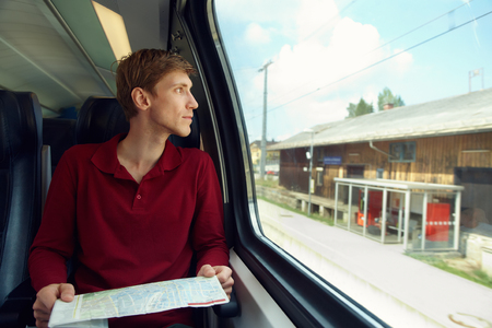 handsome man riding on a trainの写真素材