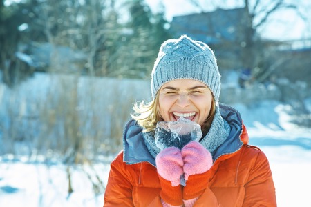 playful woman in the winter walking in a parkの写真素材