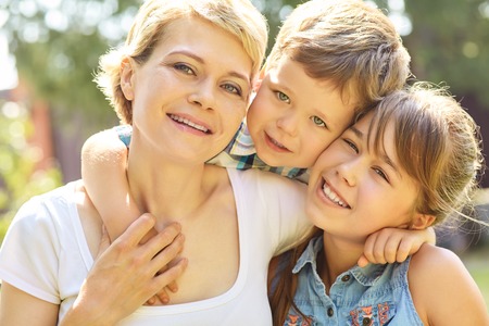portrait of a family outdoors. mom with children in the summer. Mother and kidsの写真素材