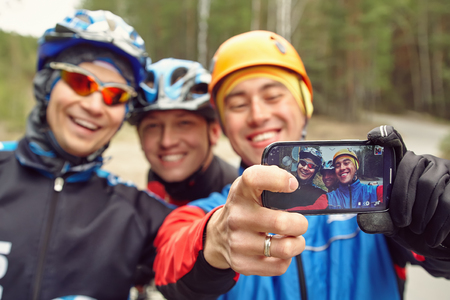 group of cyclists in helmets taking selfie photo. team outdoorsの写真素材