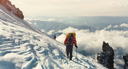 Group of hikers in the mountain. Climb to the top. climbers with backpacks on trail.