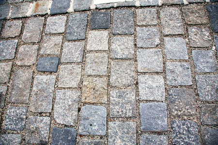 Road paved with paving stones. Cobbles background.の写真素材