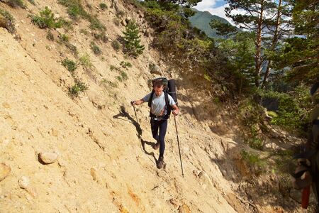 hiker in the mountains. climber with backpackの写真素材