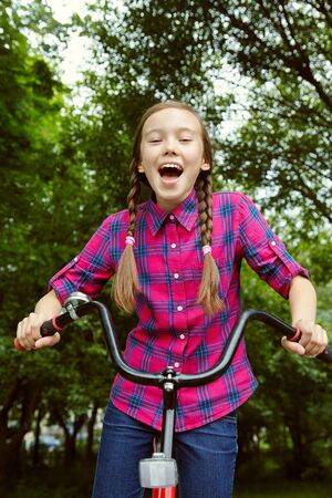 teenage girl in a park with a bicycleの写真素材