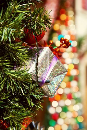gift box on background multicolored blurred lights. decorations for Christmas and New Yearの写真素材