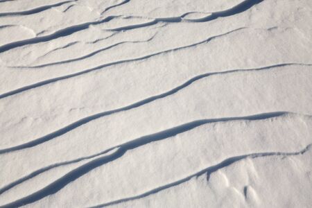 narrow elongated ridges of snow across the wind. landform background.の写真素材