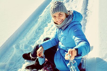 cheerful woman in the winter taking selfie photo.の写真素材