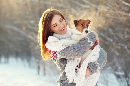 Jack Russell Terrier dog with owner in the winter outdoorsの写真素材