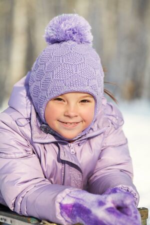 portrait of a funny little girl on a walk in the winter. child outdoors.の写真素材