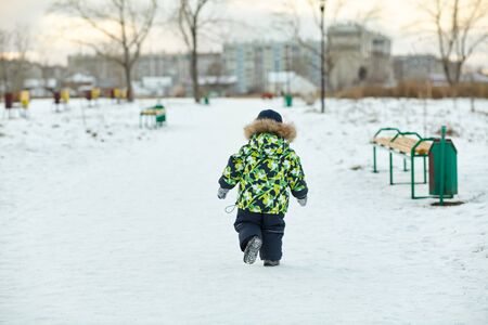 walking funny little boy in the winter. child outdoorsの写真素材