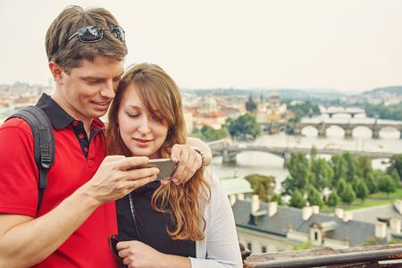 young couple in love walking on a street of European city. sightseeing traveler taking selfie photo.の写真素材