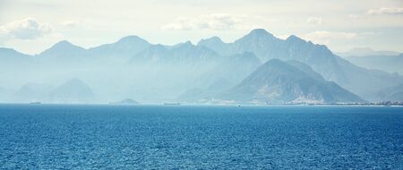 picturesque landscape with sea, mountains and clouds. blue nature of a bayの写真素材