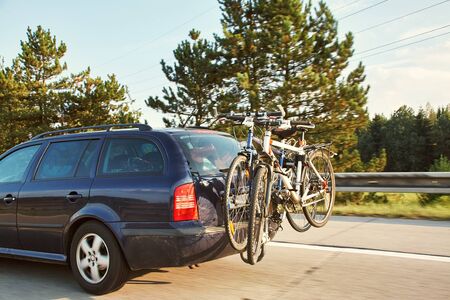 car is transporting bicycles on rack. bikes on the trunk.の写真素材