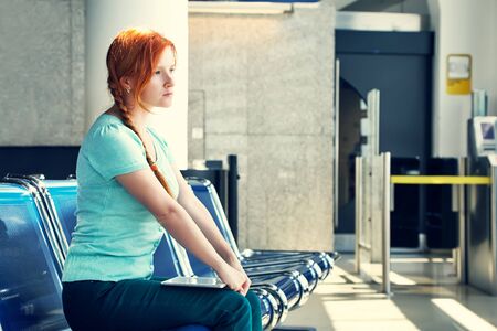 woman at the airport. redhead girl with tablet computer. business and travelの写真素材