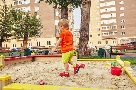 active little boy on playground. playing child in sandbox.の写真素材