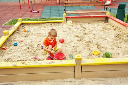 active little boy on playground. playing child in sandbox.の写真素材
