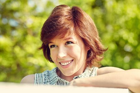 outdoor summer portrait of a happy smiling young woman.の写真素材