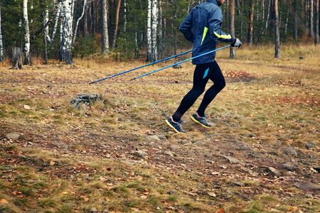 Nordic walking man. athlete jogging. sport outdoors. effect of motion blurの写真素材