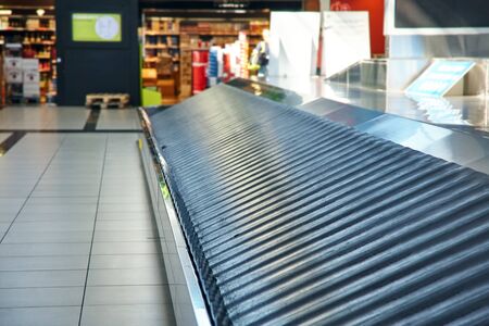 Empty conveyor belt at baggage claim at airport.の写真素材